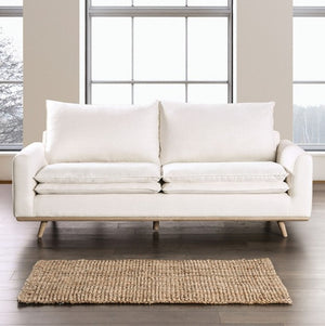 Bengie Modern Oak White Linen Fabric Sofa White sofa in a room with large windows and a rug on the floor.