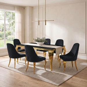 Betsy Black Glass Top Modern Dining Table A modern dining room set featuring a rectangular black table with gold legs and six matching black velvet chairs with gold legs, arranged on a light beige rug in a bright room with a window and pendant light.