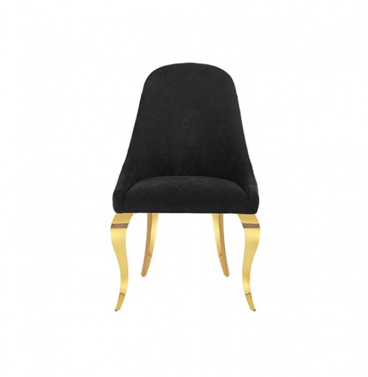 Betsy Black Upholstered Modern Chair (2/CTN) A modern dining chair upholstered in black velvet with curved gold metal legs, styled in a bright room next to a small marble-top side table.