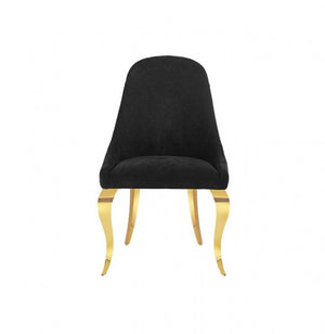 Betsy Black Upholstered Modern Chair (2/CTN) A modern dining chair with a black upholstered seat and backrest, supported by four curved gold metal legs, shown against a plain white background.