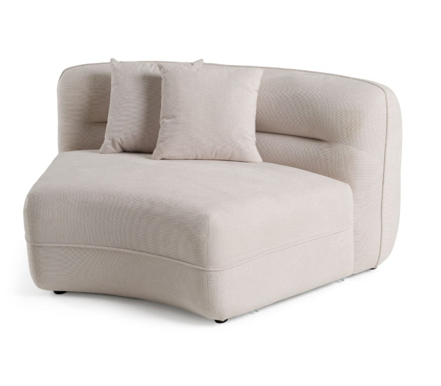 Boniser Modern Curved Off White Sectional Sofa A luxurious white curved modular sofa in a grand, elegant room with warm gold and cream lighting, a round wooden coffee table, and a beige rug.