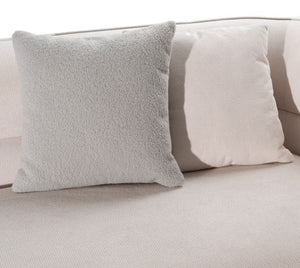 Boniser Modern Curved Off White Sectional Sofa Two square throw pillows on a light beige sofa, one in a soft textured gray fabric and the other in a cream-colored woven fabric.