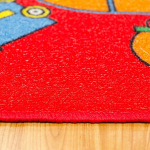 Brightstar ABC Train Red Kids 5x8 Area Rug Close-up of a colorful children's rug with cartoon characters on a wooden floor.