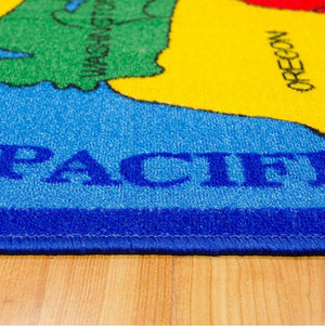 Brightstar US-Map Kids 5x8 Area Rug Colorful rug with a map design featuring states and the word 'PACIFIC' on a wooden floor.