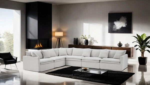 Bryant Sectional Sofa Linen Light Gray Fabric Modern living room with a white sectional sofa, black coffee table, and decorative elements.