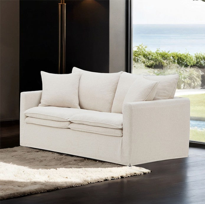 White sofa in a modern living room with large windows.