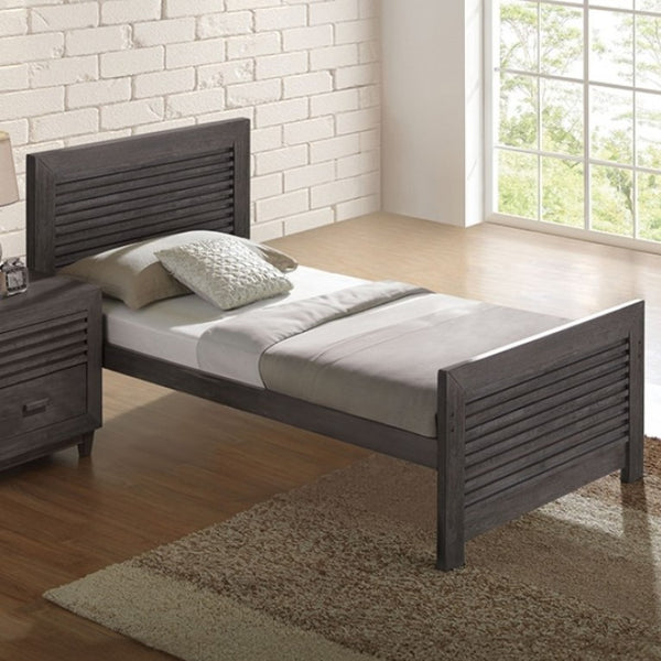 Buck Charcoal Brown Solid Hardwood Twin Bed Wooden bed with white bedding in a room with a brick wall and window.