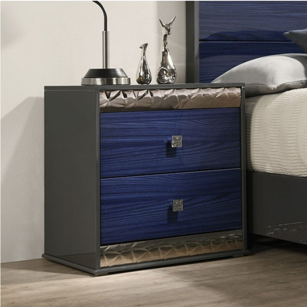 Burbandy Modern Glam Nightstand Blue nightstand with metallic accents next to a bed