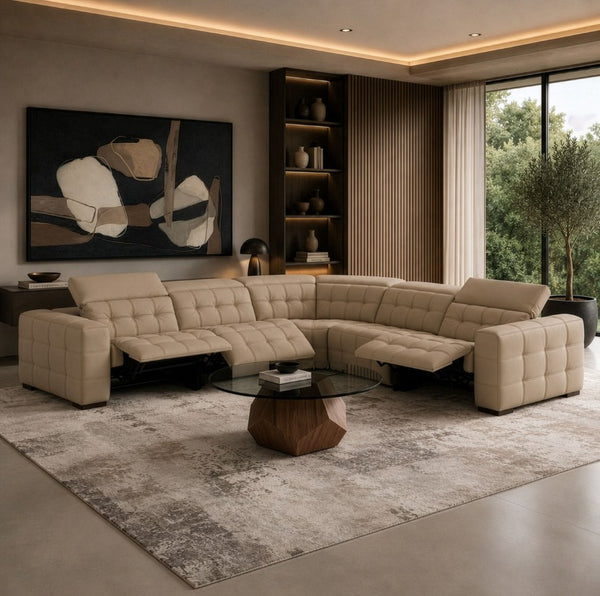 Carney 3 Recliners Beige Leather Modern Sectional Sofa A large tufted sectional sofa in a warm light beige/cream color, arranged in an L-shape in a modern living room with a patterned area rug, a geometric wood coffee table, and wall art.