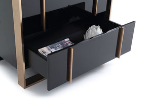 Cartier Brushed Bronze Black Chest 5 Drawer Black and bronze sideboard with open drawer displaying magazines and a flower arrangement.