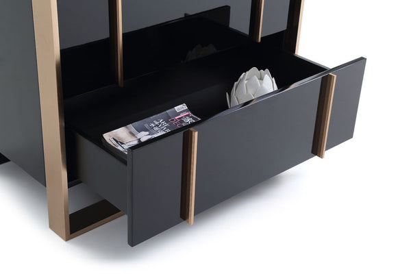 Cartier Brushed Bronze Black Chest 5 Drawer Black and bronze sideboard with open drawer displaying magazines and a flower arrangement.