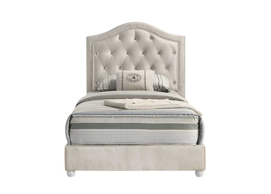 Chloe Beige Fabric Full Upholstered Kids Bed A modern bedroom furniture set featuring an off-white tufted bed frame, matching dresser, chest, and nightstand, styled in a contemporary bedroom with gray walls and a geometric rug.