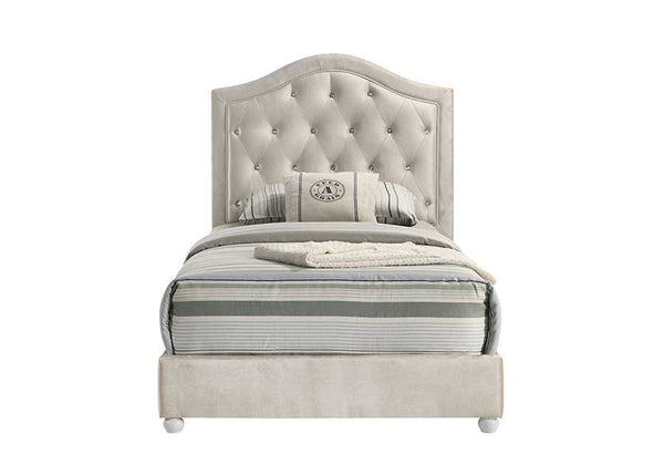 Chloe Beige Fabric Full Upholstered Kids Bed A single bed with a tall, tufted upholstered headboard and matching footboard in a light beige fabric, styled with gray and white striped bedding and pillows on a plain white background.