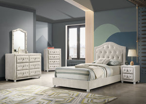 Chloe Beige Fabric Full Upholstered Kids Bed A modern bedroom furniture set featuring an off-white tufted bed frame, matching dresser, chest, and nightstand, styled in a contemporary bedroom with gray walls and a geometric rug.