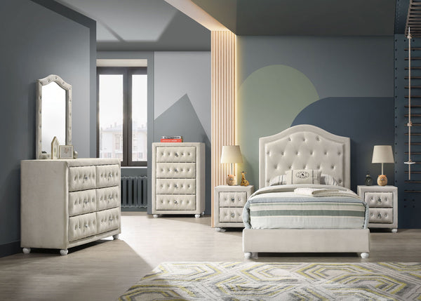 Chloe Beige Fabric Full Upholstered Kids Bed A coordinated bedroom furniture set in a modern room, including a tufted white bed frame with striped bedding, matching nightstands, a dresser, and a tall chest, set against gray walls with geometric accents.