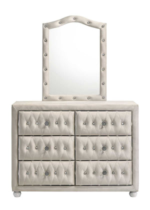 Chloe Beige Fabric Full Upholstered Kids Dresser An upholstered dresser with six drawers and a matching arched mirror, both in a light warm gray or off-white fabric with silver tufting and nailhead trim, shown on a plain white background.