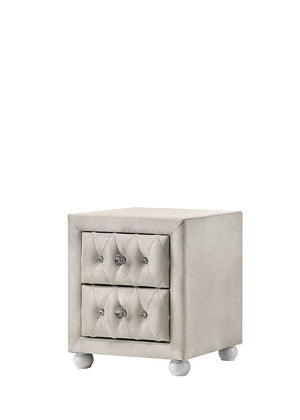 Chloe Beige Fabric Full Upholstered Kids Nightstand A small upholstered two-drawer nightstand in a light warm gray or greige fabric, featuring tufted drawer fronts with round silver knobs and short round feet, shown on a plain white background.