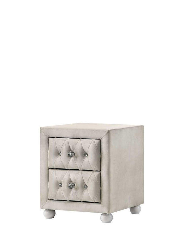Chloe Beige Fabric Full Upholstered Kids Nightstand A small upholstered two-drawer nightstand in a light warm gray or greige fabric, featuring tufted drawer fronts with round silver knobs and short round feet, shown on a plain white background.