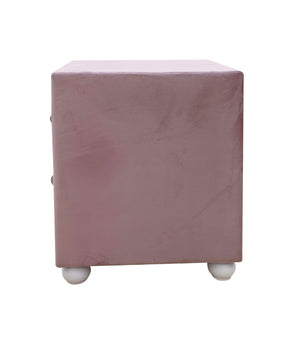 Chloe Pink Fabric Full Upholstered Kids Nightstand A dusty pink velvet cube ottoman or side table with small white spherical feet, shown from the front on a plain white background.