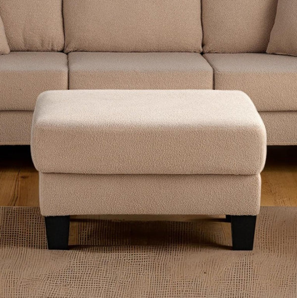 Cidney Contemporary Beige Fabric Ottoman Beige ottoman in front of a beige sectional sofa on a wooden floor.