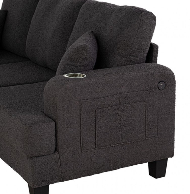 Cidney Contemporary Dark Gray Fabric Sofa Gray sectional sofa with ottoman on a wooden floor in a room with curtains.