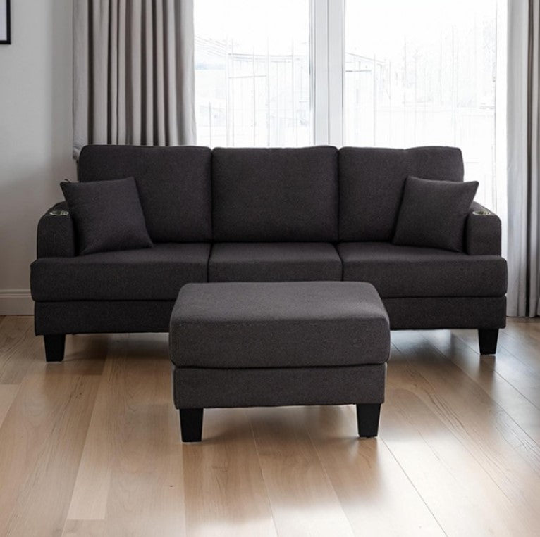 Cidney Contemporary Dark Gray Fabric Sofa Gray sectional sofa with ottoman on a wooden floor in a room with curtains.