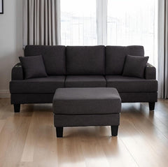 Cidney Contemporary Dark Gray Fabric Sofa Gray sectional sofa with ottoman on a wooden floor in a room with curtains.