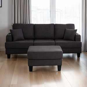 Cidney Contemporary Dark Gray Fabric Sofa Gray sectional sofa with ottoman on a wooden floor in a room with curtains.