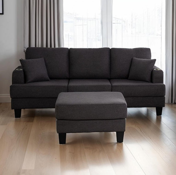 Cidney Contemporary Dark Gray Fabric Sofa Gray sectional sofa with ottoman on a wooden floor in a room with curtains.