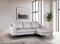 Dante Leather Match Light Gray Sectional Sofa Gray sectional sofa in a modern living room with large windows and minimal decor.