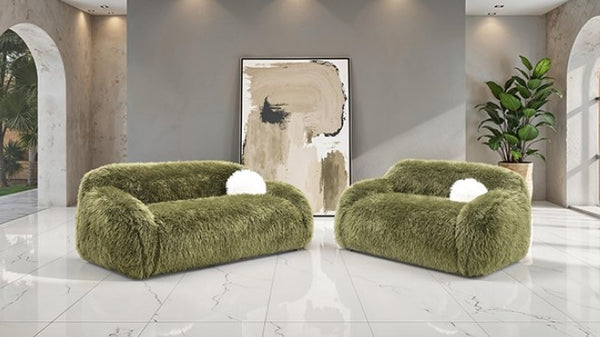 Dareen Contemporary Green Faux Fur Sofa with Ball Pillows Two green furry armchairs in a modern room with abstract art and plants.