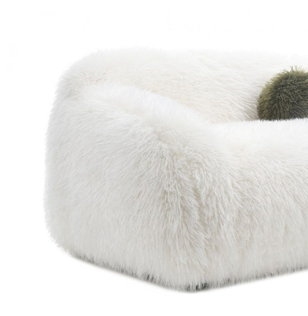 Dareen Contemporary White Faux Fur Sofa with Ball Pillows Close-up of a white fur product on a white background