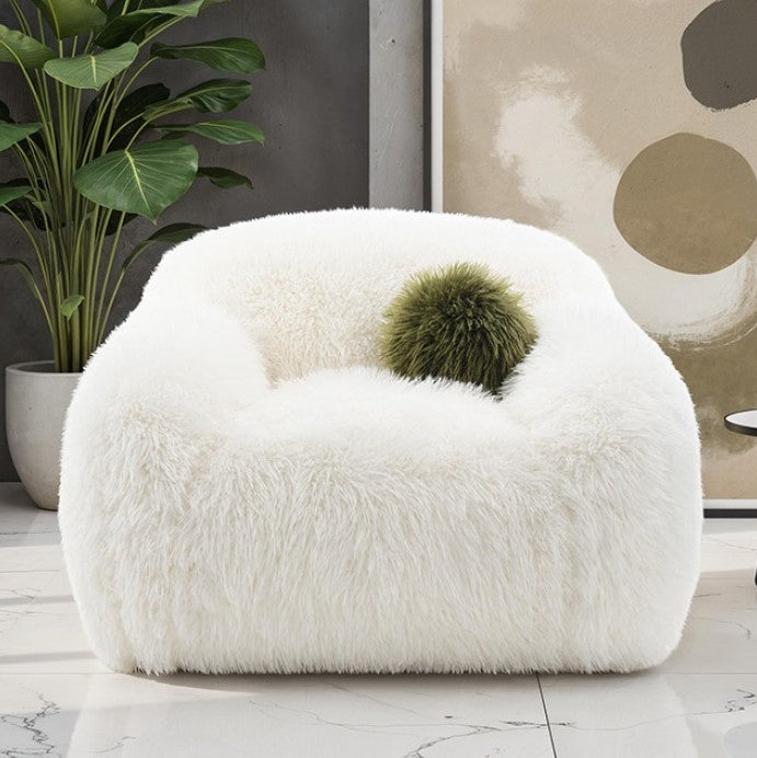 Dareen Contemporary White Faux Fur Swivel Chair with Ball Pillows White fluffy chair with a green ball in a room with a plant and abstract art.