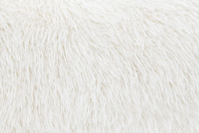 Dareen Contemporary White Faux Fur Sofa with Ball Pillows White fluffy chair with a green cushion in a modern room.