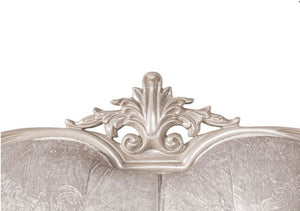 Decorative headboard with intricate silver carvings on a white background