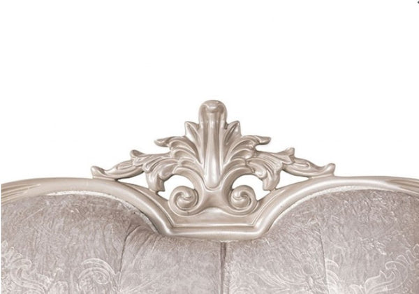 Decorative headboard with intricate silver carvings on a white background