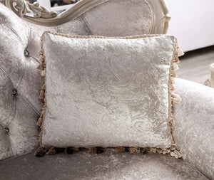 Decorative pillow with intricate patterns on a gray sofa