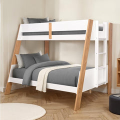 Davin Twin Full Bunk Bed White Natural White and wooden bunk bed with gray bedding in a room.