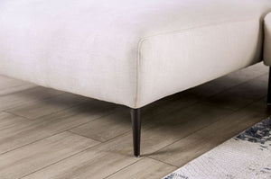 Beige sofa corner on a wooden floor with a rug