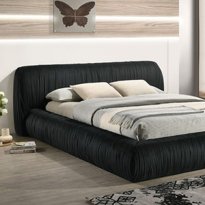 Decodale Black Fabric Pleated Fully Upholstered Platform Bed Modern bedroom with a black upholstered bed and decorative elements.