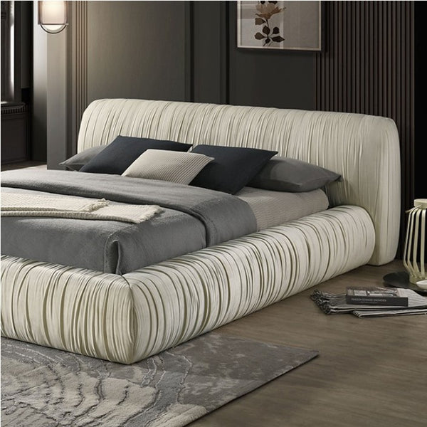 Decodale Ivory Fabric Pleated Fully Upholstered Platform Bed Modern bedroom with a large bed featuring striped headboard and bedding.