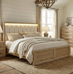 Delmar Natural Finish Upholstered Bed Neatly made bed with wooden headboard in a bedroom setting.
