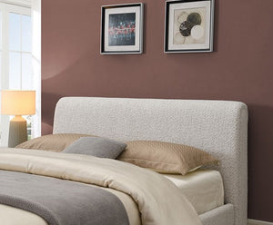 Doira Modern  Style Upholstered Bed White Finish Bedroom with a bed featuring textured headboard, pillows, and a lamp on a brown wall.