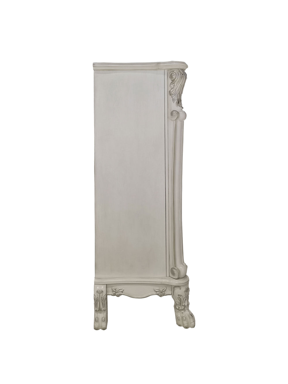 Dresden Bone White Traditional Style Chest An ornate white carved wooden cabinet or sideboard in a styled bedroom setting, with a silver candelabra on top, framed photos, a mirror, curtains, and part of a tufted upholstered bed visible in the foreground.