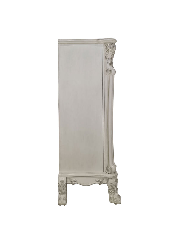 Dresden Bone White Traditional Style ChestDresden Bone White Traditional Style Chest A tall, narrow cabinet or armoire in a distressed off-white finish, featuring ornate carved details on the top corner, side trim, and feet, shown against a plain white background.