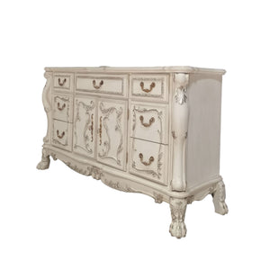 Dresden Bone White Traditional Style Dresser An ornate vintage-style sideboard cabinet in a distressed off-white finish with gold-toned metal handles and carved decorative details, shown against a plain white background.