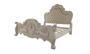 Dresden Bone White Traditional Silhouette Upholstered Bed An ornate baroque-style bed frame in a distressed off-white finish, featuring a tufted upholstered headboard and matching carved footboard, shown against a plain white background.