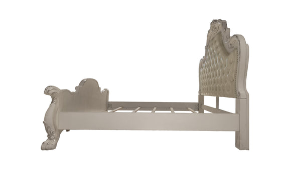 Dresden Bone White Traditional Silhouette Upholstered Bed An ornate, vintage-style bed frame in a light beige or off-white finish, featuring a high tufted headboard, carved footboard, and decorative side rails, shown against a plain white background.