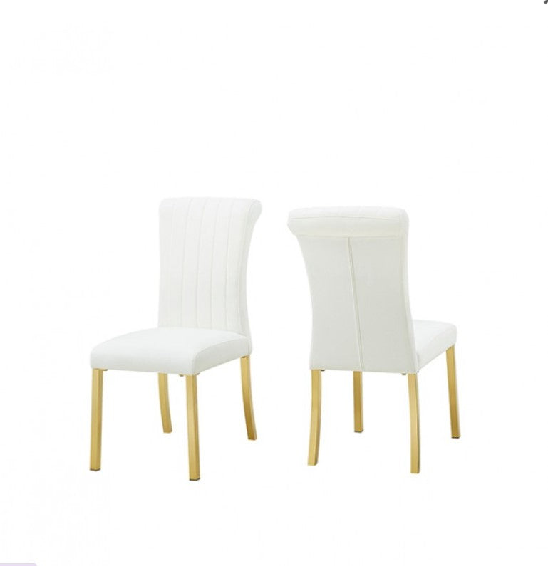 Editta Modern Glam Gold White Dining Chair White chairs with gold legs on a reflective surface, grassy area in the background