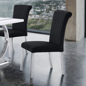 Editta Modern Glam Silver Black Dining Chair Black upholstered chairs with silver legs in a modern interior setting.